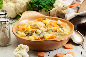 Vegetable soup with ingredients carrot, cauliflower, potato and parsley