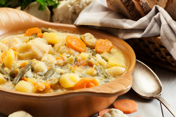 Vegetable soup with ingredients carrot, cauliflower, potato and parsley