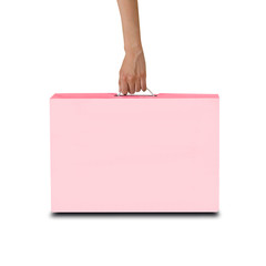 Hand holds a pink box with a handle. Packing box for laptop. Isolated on white background