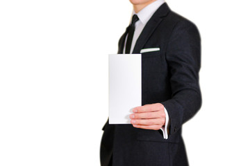 Man showing blank black flyer brochure booklet. Leaflet presentation. Pamphlet hold hands. Man show clear offset paper. Sheet template. Man in a black suit, white shirt and tie.