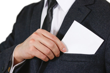 Businessman putting paper in suit pocket closeup. Showing blank flyer brochure booklet. Pamphlet hold hands. Show clear offset paper. Sheet template. Man in a black suit, white shirt and tie