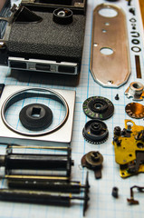 parts old retro film SLR camera on graph paper