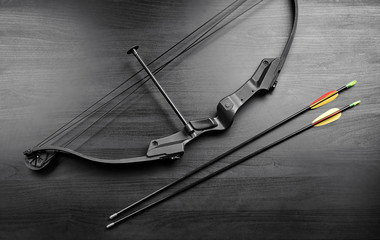 Bow with arrows on table