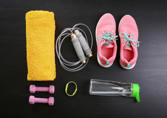 Composition with towel and sport equipment on wooden background