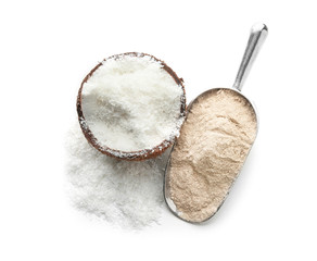Scoop with flour and desiccated coconut in nut on white background