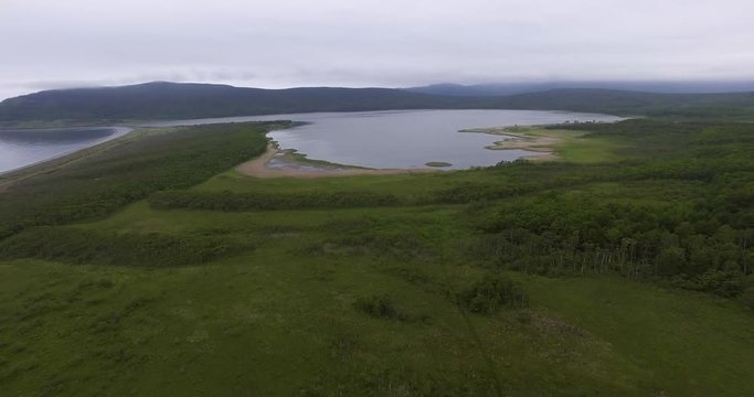 Descending aerial view of the birdman house near lake Blagodatnoye at the Sikhote-Alin Nature Reserve in Russian Far East. It has been inscribed on the UNESCO World Heritage List since 2001.