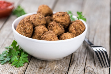 Meatballs on an old wooden table (selective focus)
