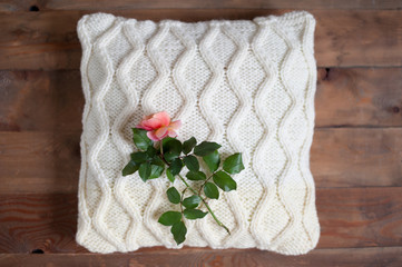 The rose lies on a crocheted pillow