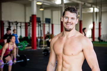 Obraz premium Confident Muscular Man Standing In Gym