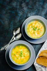 Healthy vegan turmeric coconut split pea soup on dark blue stone background. Top view, copy space. 