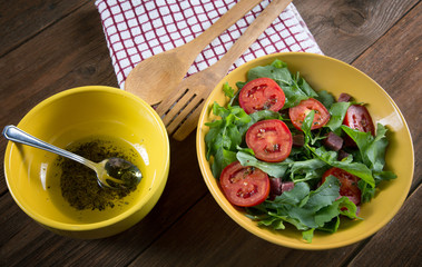 Vegetable salad with tomatoes and arugula on the table