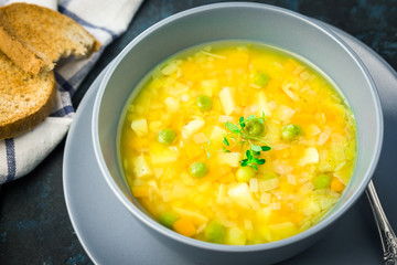 Vegan split pea soup with turmeric on dark blue stone background. Top view, copy space. 