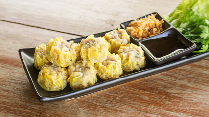 Chinese Steamed Dumpling on a black plate.