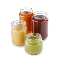 Glass jars with nutrient baby food on white background