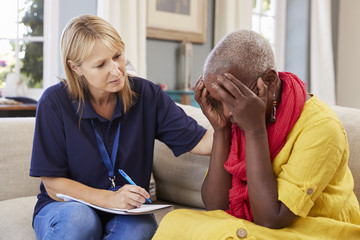 Support Worker Visits Senior Woman Suffering With Depression