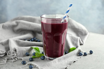 Glass with acai juice on table
