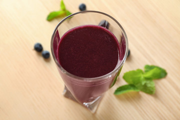 Glass with acai juice on table