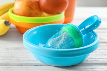 Baby's nibbler in plastic bowl on table