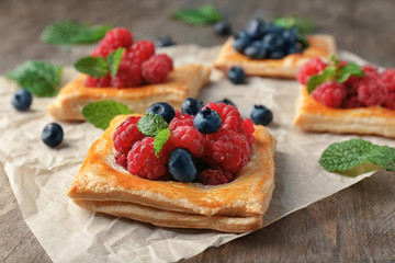 Delicious pastry with berries on table