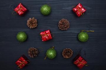 Christmas tree toys different colors balls, gifts, deer mask on a dark background, Christmas New Year holidays preparation concept. Horizontal. Top view.