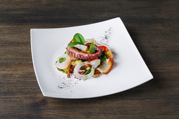 Salad with octopus and vegetables top view