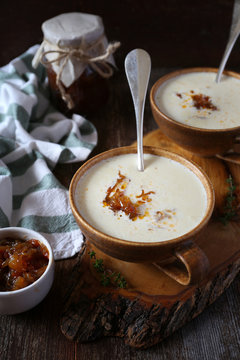 Two portions of onion cream soup with caramelized onions, rustic style