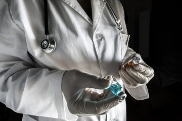 Doctor holds two vials in a hospital. Conceptual image