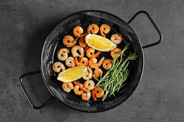 Dish with delicious grilled shrimps on table