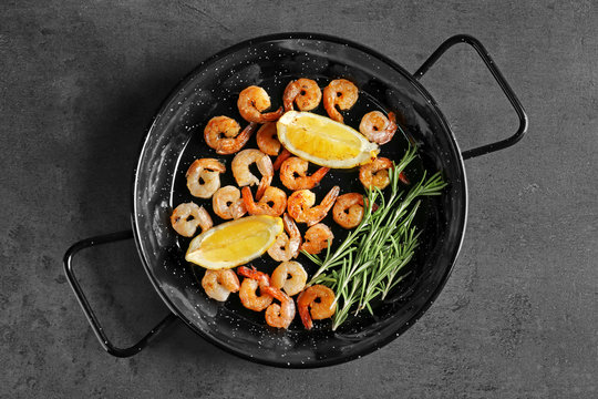 Dish with delicious grilled shrimps on table