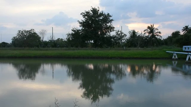 Motion and wave water in canal watercourse waterway of water supply with water pipe at countryside while sunset time in Nonthaburi, Thailand