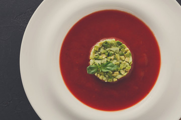 Cold tomato soup gazpacho with avocado close up