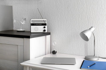 Modern radio on chest of drawers in room