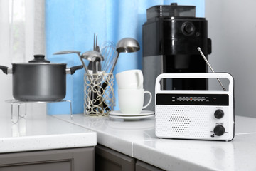 Modern radio on table in kitchen