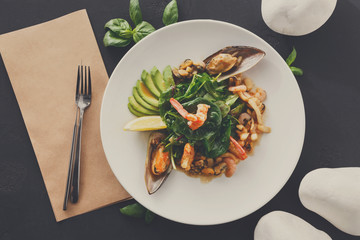 Warm salad with grilled seafood flat lay