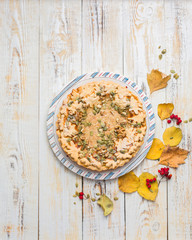 Autumn background with pumpkin pie, hot tea, yellowed leaves, book and rug. Perfect sunny autumn. A wooden light white autumn background for you. Copy Space. Place for text. Flat lay, top view