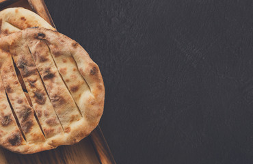 Tandoori bread on black background, copy space