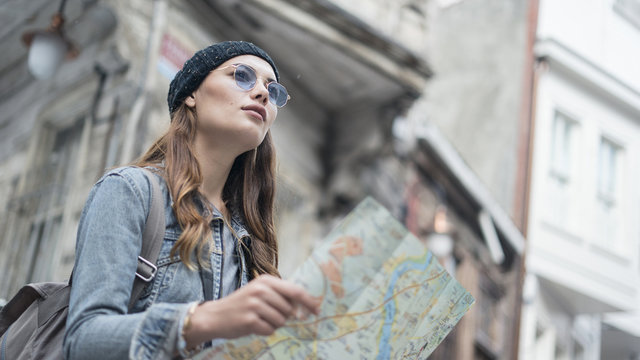 Young tourist woman hand map in outdoors