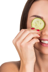 woman with sliced cucumber for skincare mask