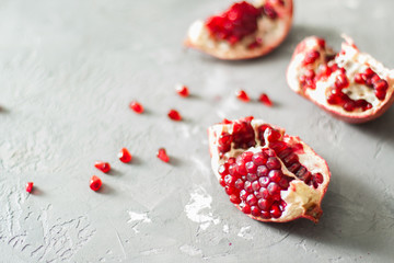Fresh pomegranate on a concrete background. Still life. Place for text. 