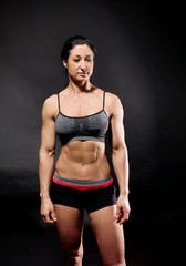 Muscular bodybuilder woman showing her muscles.