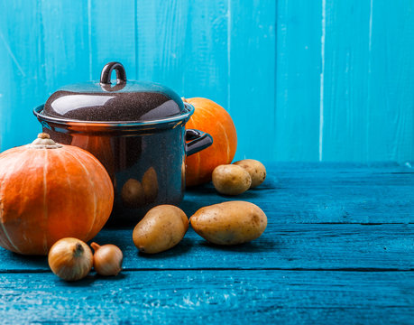 Picture of iron pot with lid, vegetables, potatoes, pumpkin, onions