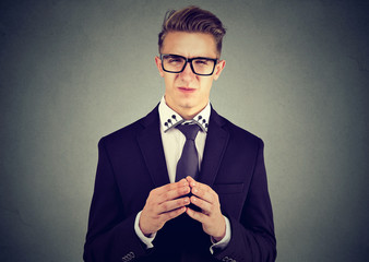 Sly business man in glasses looking at camera 