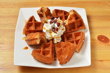 Waffle with whipped cream.caramel and cranberry