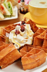 Waffle with whipped cream.caramel and cranberry