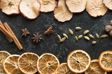 Fototapeta na wymiar dried apples and oranges with cinnamon sticks