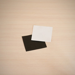 Two blank square paper. White and black note.