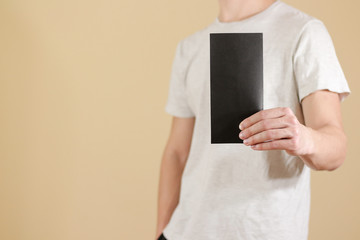 Man showing blank black flyer brochure booklet. Leaflet presentation. Pamphlet hold hands. Man show...