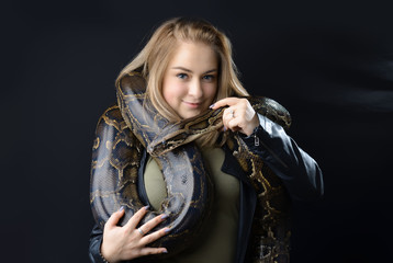 beautiful portrait yong girl and giant snake in the studio