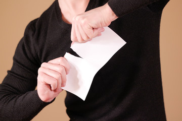 Man tearing a piece of paper in half blank white flyer brochure booklet. Leaflet presentation....