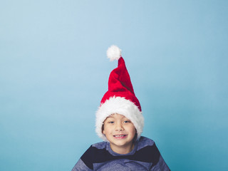 young 5 year old boy with christmas decoration on his hat